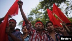 Activists and garment workers shout slogans during a protest demanding a minimum wage of 8,000 Bangladeshi Taka [$100] in Dhaka, Bangladesh, Nov. 8, 2013.