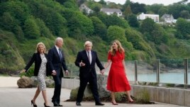 President Joe Biden and first lady Jill Biden are greeted and walk with British Prime Minister Boris Johnson and his wife Carrie Johnson, ahead of the G-7 summit, Thursday, June 10, 2021, in Carbis Bay, England. (AP Photo/Patrick Semansky)