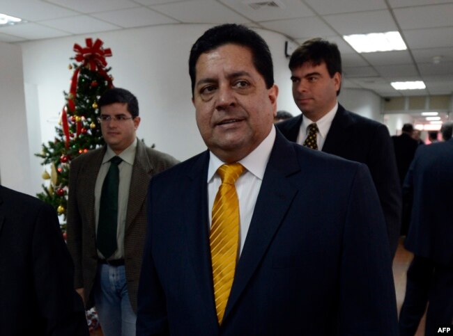 In this file photo taken on Jan. 7, 2013, opposition deputy Edgar Zambrano walks to a meeting of the country's clergy in Caracas.