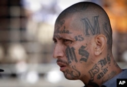 FILE - A member of the MS-13 gang attends mass at a prison in Ciudad Barrios, El Salvador, March 26, 2012. U.S. law enfrocement aims to dismantle the entire leadership structure of the MS-13, including those members who are active overseas.