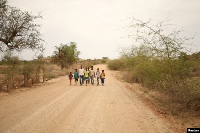 Students walk home from school in the outskirts of Badme, territorial dispute town between Eritrea and Ethiopia currently occupied by Ethiopia, June 8, 2018.