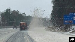 This image provided by the South Carolina Department of Transportation shows crews plowing snow and ice in York County, Jan. 16, 2022.