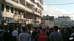 Protesters gather during a demonstration in the Syrian port city of Banias, April 26, 2011