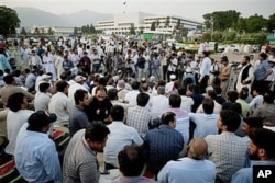 FILE - Pakistani journalists hold a protest rally and sit-in-protest outside the Parliament to condemn the killing of their colleague, Syed Salim Shahzad, this week after he reported being threatened by intelligence agents, in Islamabad, Pakistan, June 15, 2011.