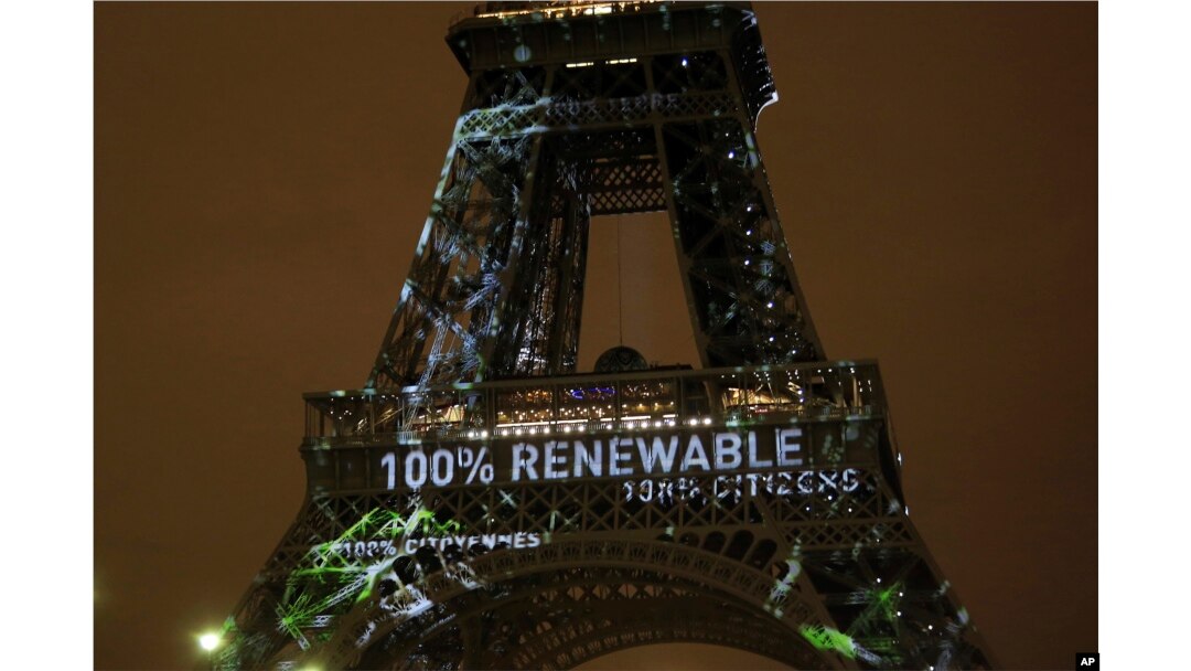 FILE- Artwork entitled "One Heart One Tree" by artist Naziha Mestaoui is displayed on the Eiffel tower ahead of the 2015 Paris Climate Conference, in Paris, Nov. 29, 2015.