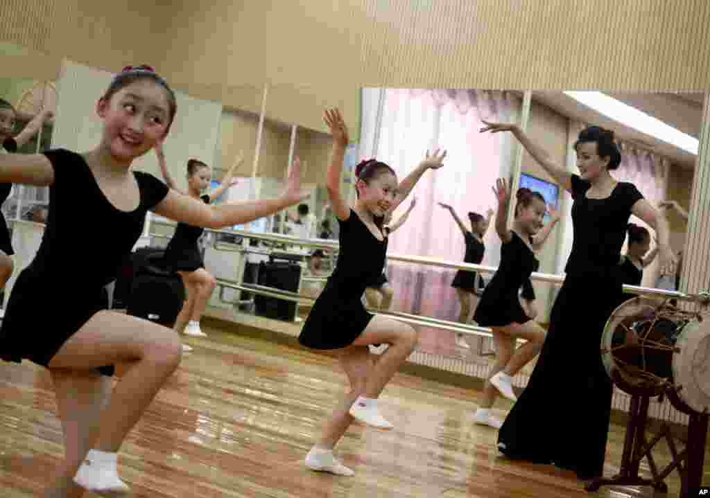 Girls dance in a studio at the Mangyongdae Children's Palace in Pyongyang, North Korea.