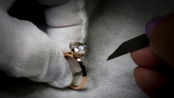 A worker inspects a ring set with an Aether diamond made from captured CO2, at the RFG Manufacturing Riviera jewelry design facility in New York City, New York, September 30, 2021. REUTERS Mike Segar