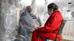 The tent includes a construction-grade plastic barrier with built-in plastic sleeves to prevent the spread of the coronavirus, in Louisville, Colorado, on Wednesday, Feb. 3, 2021. (AP Photo/Thomas Peipert)