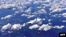 FILE - South Korean F-15K fighter jets and U.S. F-35B stealth jet fighters fly over South Korea during a joint military drill aimed to counter North Korea’s latest missile test, Aug. 31, 2017. (South Korean Defense Ministry photo)