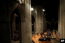 FILE - Candles are lit during a vigil for victims of the 2012 shooting at Sandy Hook Elementary School in Newtown, Conn. and other victims of gun violence at the National Vigil for Victims of Gun Violence at the National Cathedral in Washington, Dec. 12, 2013.