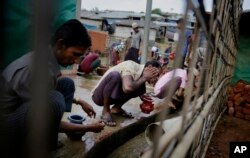 Rohingya refugees perform ablution before offering Eid al-Adha prayers at Kutupalong refugee camp, Bangladesh, Aug. 22, 2018.