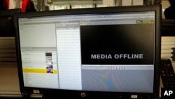FILE - The screen of a hacked computer is seen in an office.