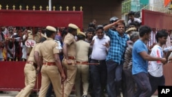 India Film Kabali: Policemen try to maintain the order of the fans of Indian superstar Rajinikanth as they enter the premises of a cinema hall where the actor's new movie "Kabali" is being screened in Chennai, India, Friday, July 22, 2016.