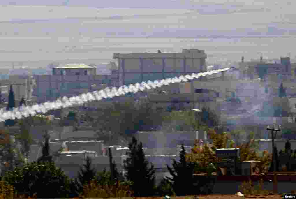 A rocket, believed to have been launched by Islamic State militants, flies from the east to the west side of the Syrian town of Kobani during fighting, Nov. 6, 2014. 