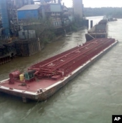 This is one of four massive barges that broke away from their towboat on the Ohio River last April. One sank.