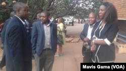 FILE: Zimbabwean journalists gather outside magistrates court in Harare.