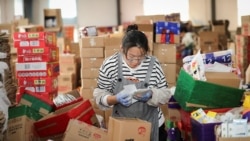 An employee checks the delivery information for packages ahead of the upcoming "Double Eleven" Online Shopping Festival day