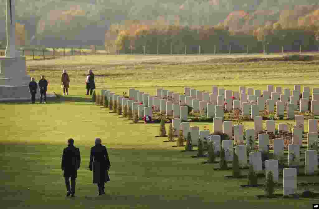 British Prime Minister Theresa May and French President Emmanuel Macron walk together after laying wreaths at the World War I Thiepval Memorial in Thiepval, France, Nov. 9, 2018.