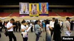 FILE - People line up to vote in the Thai election at a polling station in Bangkok, Thailand, March 17, 2019.