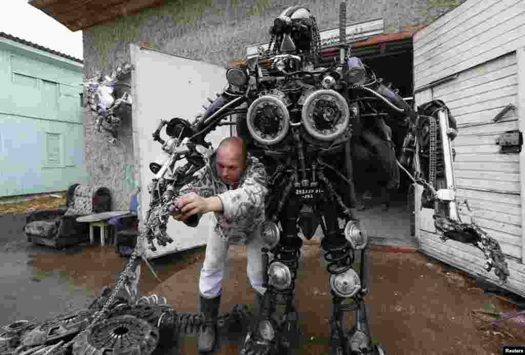 Mechanic and welder Sergei Kulagin, 32, tests the &quot;Alien Samurai&quot;, an electro-mechanical mobile robot he made from car components, outside an automobile repair workshop in the town of Divnogorsk, Siberia. 