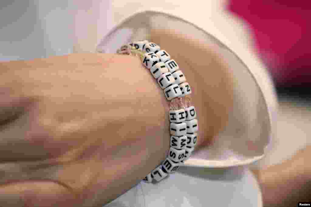 &quot;Jane Doe 15,&quot; a 31-year-old unidentified woman, who accuses the late financier Jeffrey Epstein of sexually abusing her when she was a teenager, wears a bracelet that reads &quot;Epstein didn&#39;t kill himself&quot; as she speaks at a news conference in Los Angeles, California, Nov. 18, 2019.