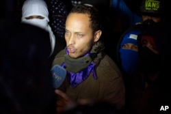 FILE - Police officer-turned-rebel Oscar Perez speaks to the press in Caracas, Venezuela, July 13, 2017.