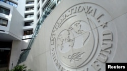 FILE - The International Monetary Fund logo is seen inside its headquarters in Washington.