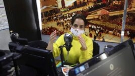 Diana Lopez presents a one-hour class through Bacata Stereo radio station in Funza, Colombia, Wednesday, May 13, 2020.