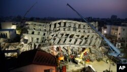 In the early morning, emergency rescuers continue to search for the missing in a collapsed building from an earthquake in Tainan, Taiwan, Feb. 7, 2016. 