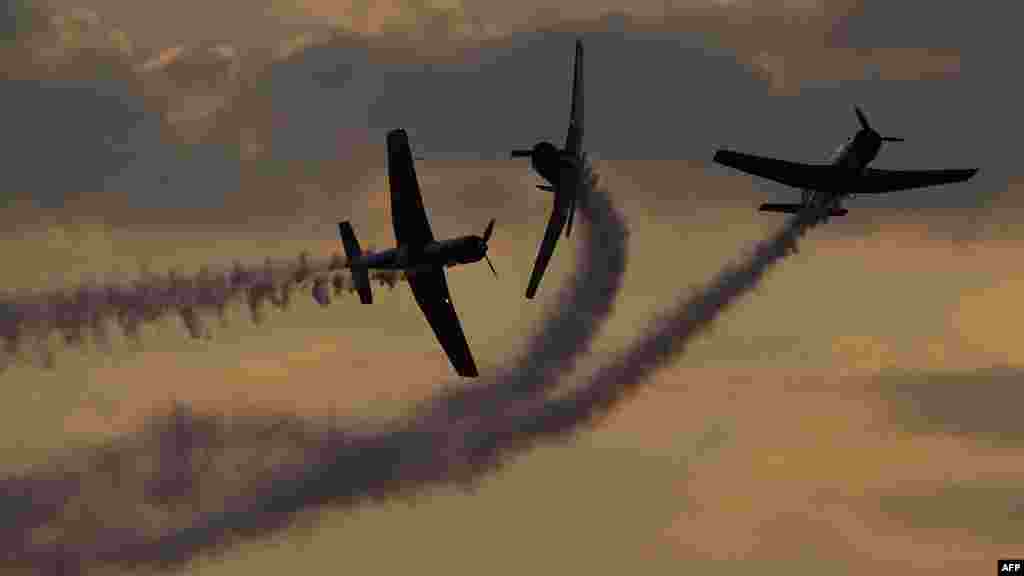 Vintage World War II-era aircraft perform aerobatics during a performance at the Australian International Airshow 2019 in Avalon.