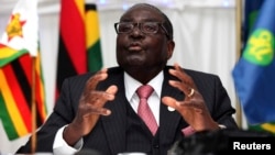 FILE: Zimbabwe President Robert Mugabe speaks at the 34th Southern African Development Conference (SADC) summit in Victoria Falls, August 18, 2014. 