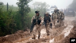 Army soldiers arrive to guard the Mariana Paez demobilization zone, one of many rural camps where FARC rebel fighters are making their transition to civilian life, one day ahead of an event with President Juan Manuel Santos in Buenavista, Colombia, June 26, 2017.