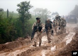 Army soldiers arrive to guard the Mariana Paez demobilization zone, one of many rural camps where FARC rebel fighters are making their transition to civilian life, one day ahead of an event with President Juan Manuel Santos in Buenavista, Colombia, June 2, 2017.