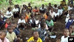 Refugee children from the Democratic Republic of Congo attend class in a forest near the town of Gangania, more than 850 km north of Brazzaville, the capital of neighboring Congo, 25 Feb 2010