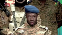 FILE - Captain Sidsore Kader Ouedraogo, spokesman for the Patriotic Movement for Safeguarding and Restoration, announces that the army has taken control of the country in Ouagadougou, Burkina Faso, Jan. 24, 2022.