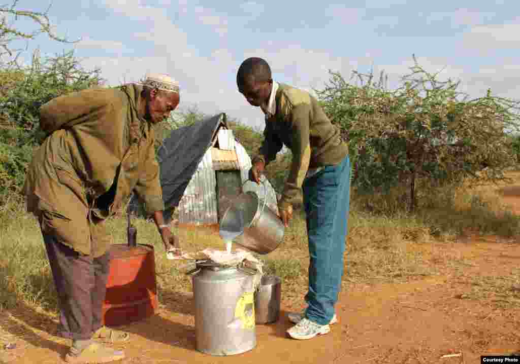 Milk from the camel herd at Mpala is poured into carrier tanks and transported by motorcycle to Kenya&#39;s only pasteurization plant. (Sharon Deem, Saint Louis Zoo)