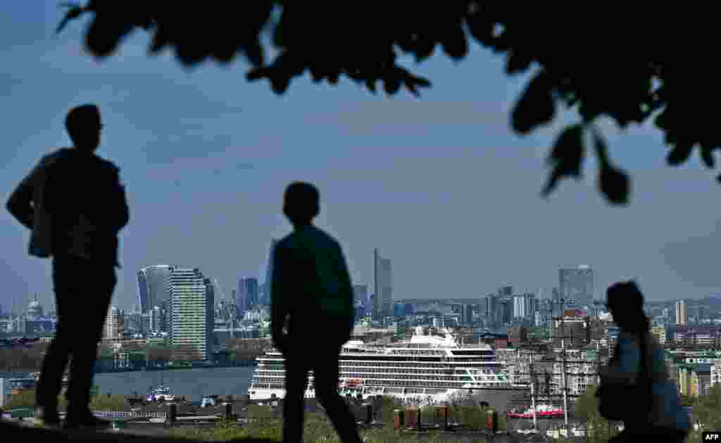 The Viking Sea cruise ship is guided by tug boats along the River Thames towards Greenwhich Pier in east London ahead of its official naming ceremony later today.