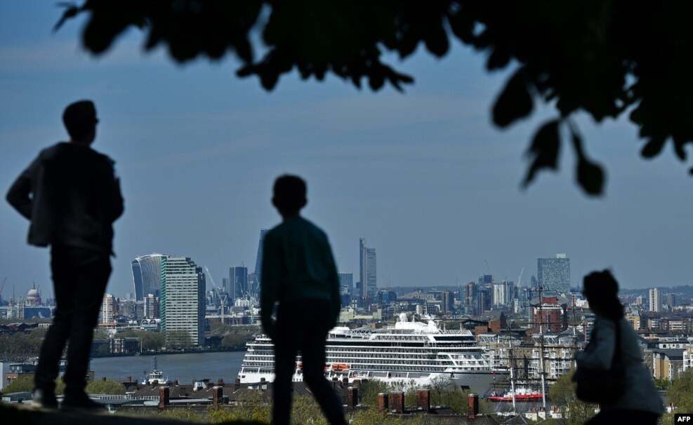 The Viking Sea cruise ship is guided by tug boats along the River Thames towards Greenwhich Pier in east London ahead of its official naming ceremony later today.