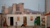 People sitting outside their shacks in the Nkaneng shantytown next to the platinum mine, run by British company Lonmin, in Marikana. South Africa, July 9, 2913.