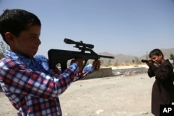 Afghan boys play with toy weapons in a celebration of the first day of Eid al-Fitr in Kabul, Afghanistan, June 25, 2017. The three-day holiday marks the end of the holy fasting month of Ramadan.