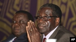 Zimbabwean Prime Minister Morgan Tsvangirai, left, and President Robert Mugabe, Harare, November 11, 2011.