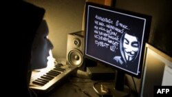 Un hacker masqué, appartenant au groupe Anonymous, pirate le site Web de la présidence française de l'Elysée le 20 janvier 2012.