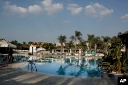This Nov. 6, 2018 photo, shows a a pool inside a gated compound in Giza, Egypt. Billboards across Cairo advertise luxury homes with “breathtaking” views.