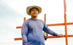 Les Kert navigates his fishing boat in Teuk Chhou district of Kampot province, on October 3, 2021. (Lors Liblib/VOA Khmer)