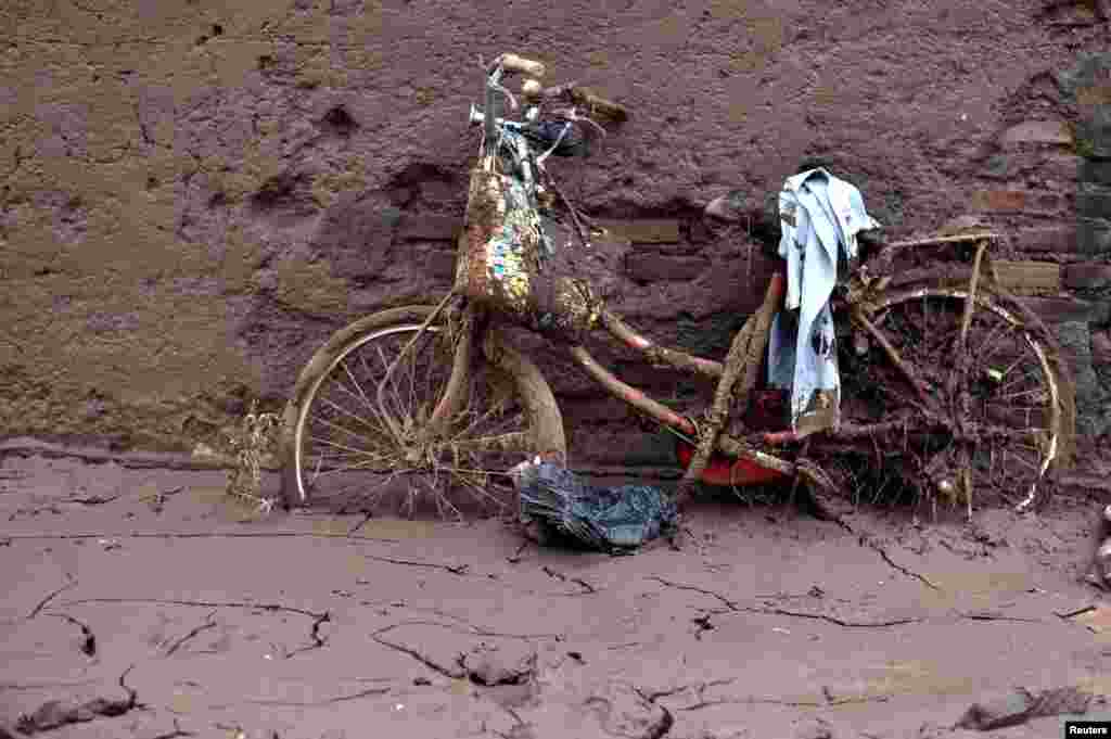 A bicycle is covered with debris after a flash flood this week in Garut, West Java, Indonesia, killed more than 20 people. Photo by Antara Foto.