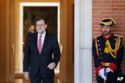 A guard looks across at Spain's Prime Minister Mariano Rajoy at the Moncloa Palace in Madrid, Spain, May 13, 2018.