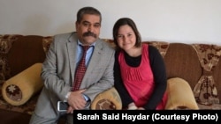 FILE - Sarah Said Haydar, 16, with her father before her capture by Islamic State militants last August. 