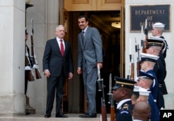 Defense Secretary Jim Mattis, left, stands with Emir of Qatar Sheikh Tamim bin Hamad al-Thani during an Honor Cordon at the Pentagon, April 9, 2018.