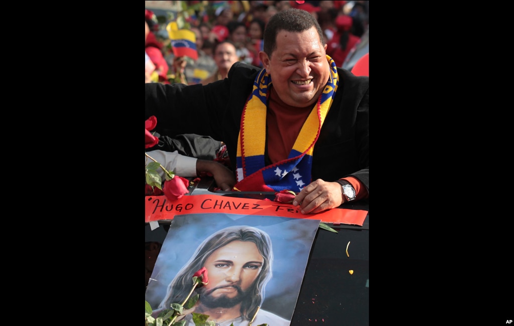 Chavez greets supporters during his caravan from Miraflores presidential palace to the airport in Caracas, February 24, 2012.