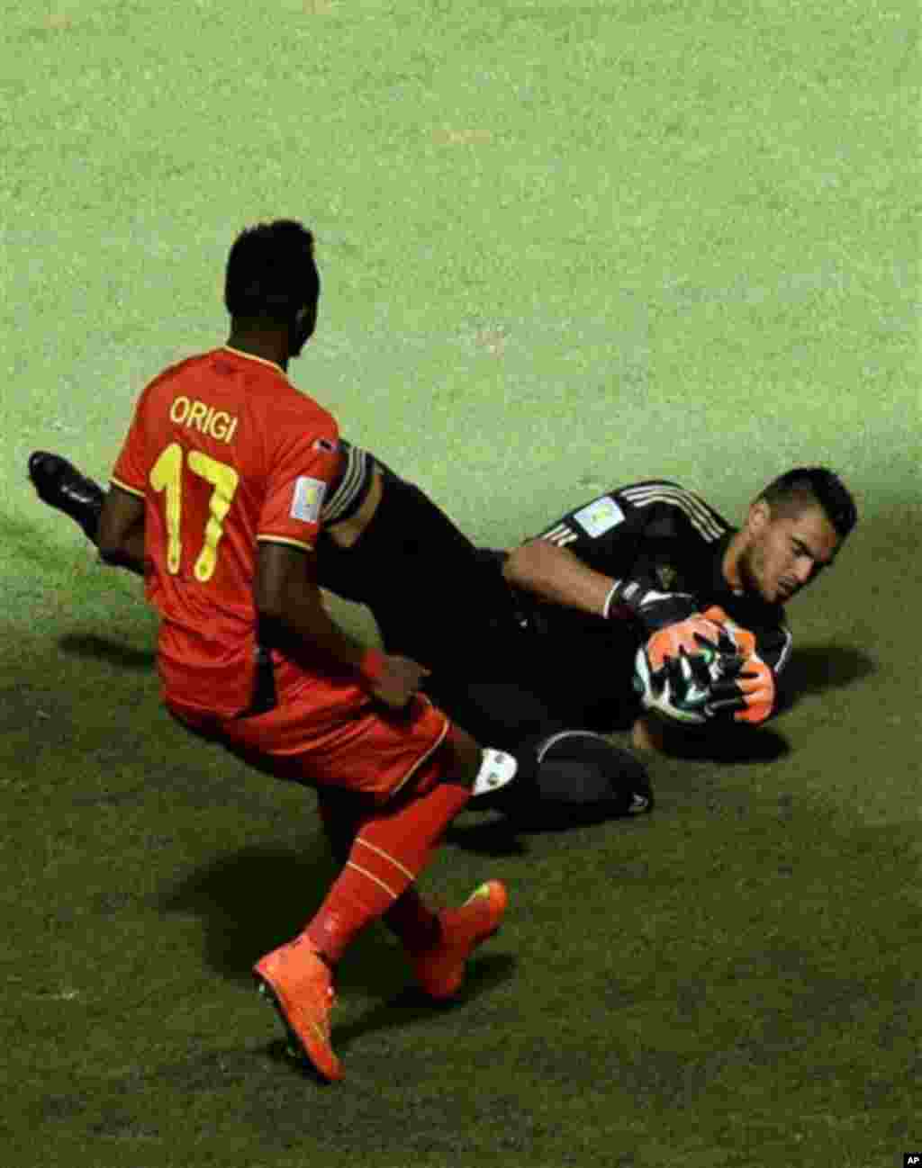 Argentina's goalkeeper Sergio Romero blocks the ball as Belgium's Divock Origi challenges during the World Cup quarterfinal soccer match between Argentina and Belgium at the Estadio Nacional in Brasilia, Brazil, Saturday, July 5, 2014. (AP Photo/Thanassis